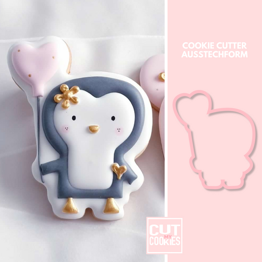 Cookie cutter penguin with heart balloon